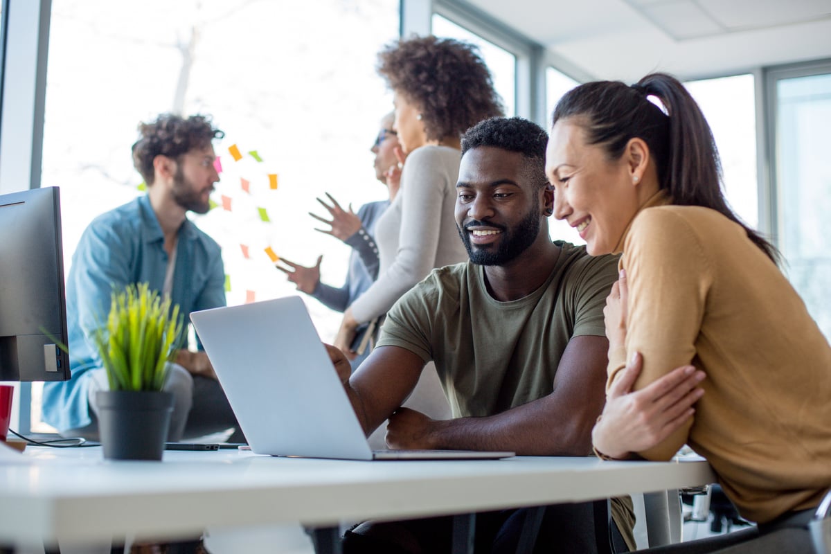 people collaborating at laptop