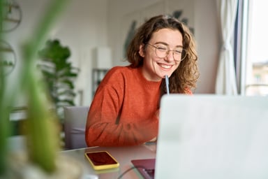 woman smiling and working remotely