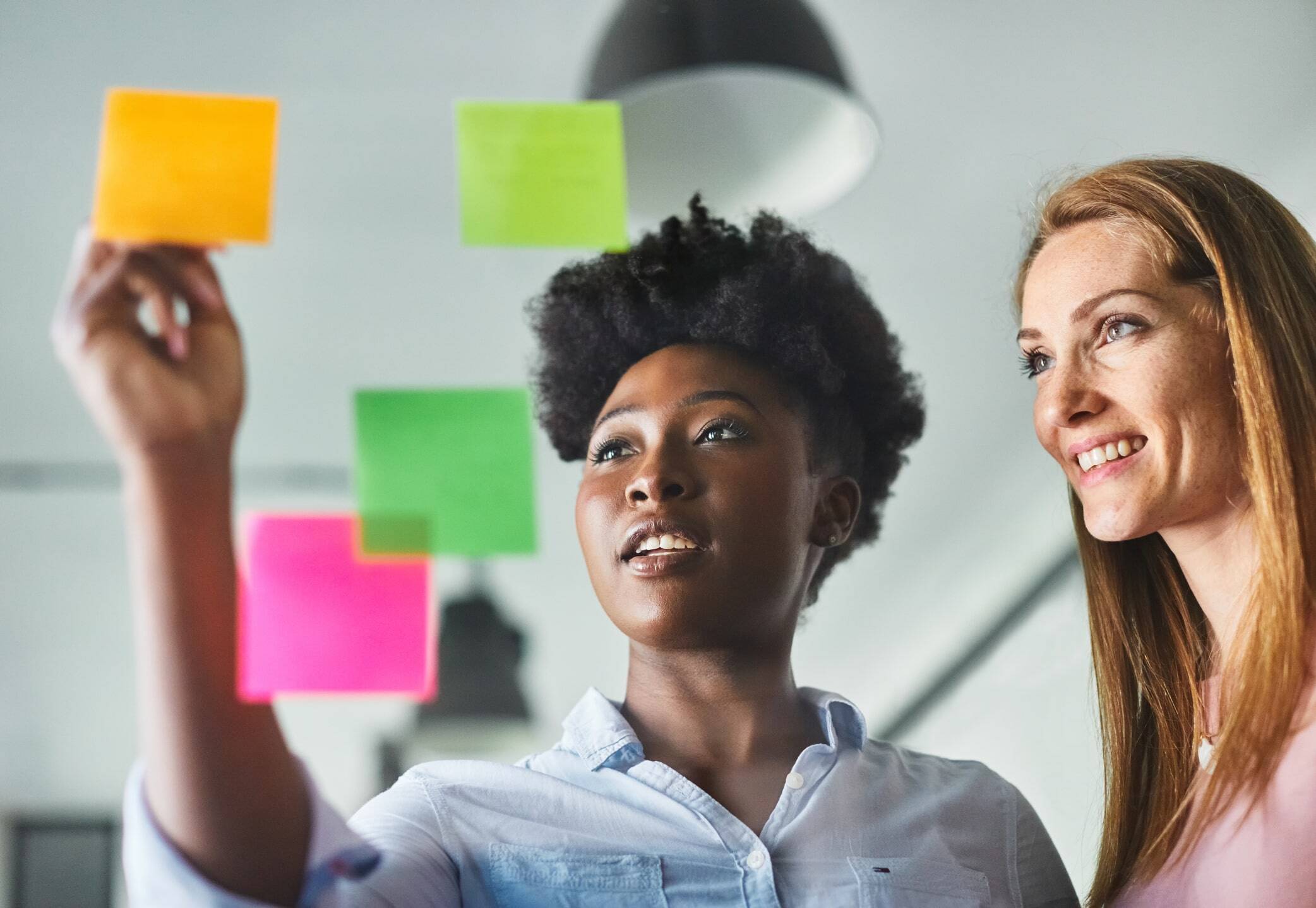 colleagues looking at post-it notes