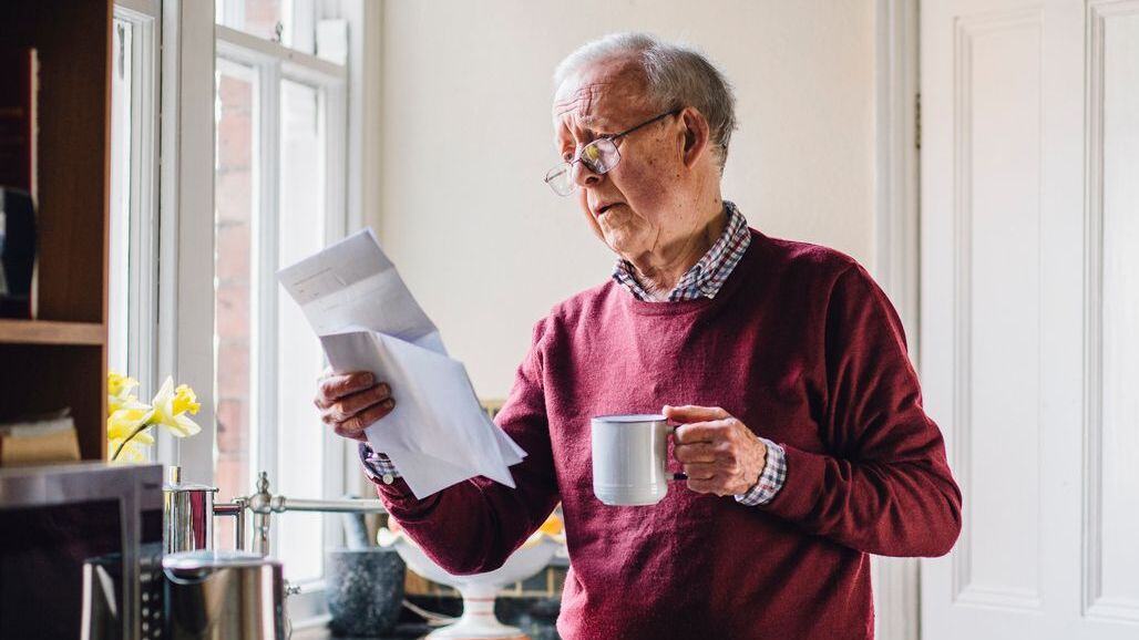 Pensioner looking at a bill